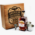 American Founders Heritage Select 250 Bourbon bottle with wooden box and metal cups on a white background